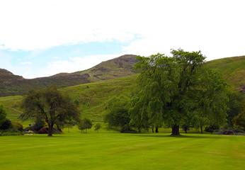 Famous hills of Holyrood Park and the Arthur's seat. View from Holyrood Palace. Edinburgh, Scotland, June.