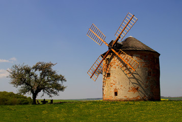 Fototapeta premium Old windmill with sunset and blue sky
