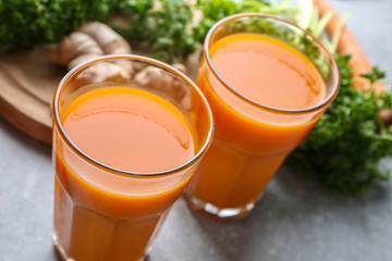 Glasses of carrot juice on light table