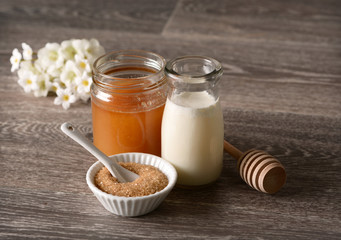Milk and honey on wooden table