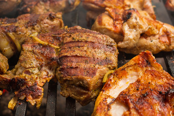 Pork steaks roast on a large grill