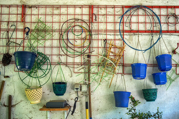 Empty flower pots.Pots and other garden tools on a garage wall shelving