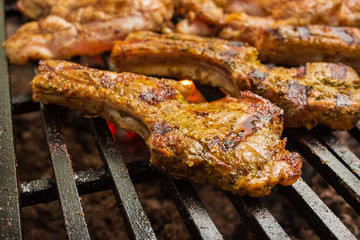 Pork steaks roast on a large grill