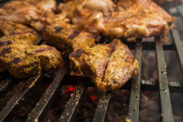 Pork steaks roast on a large grill