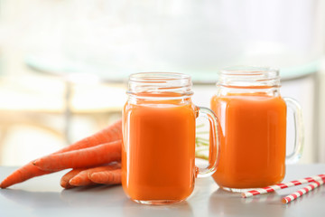 Jars of carrot juice  on table