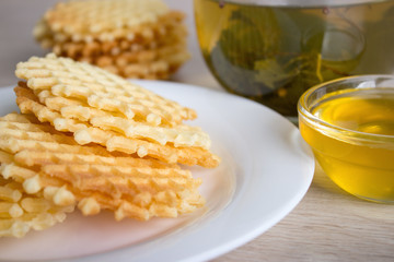 a cup of tea with waffles and honey