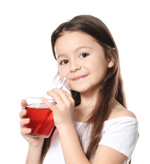 Cute little girl with glass of juice on white background