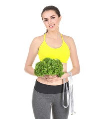 Beautiful young woman with measuring tape and lettuce on white background. Diet concept