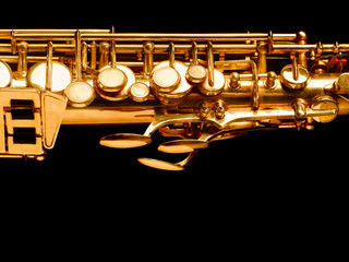 Golden saxophone on dark background