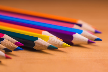Obraz premium Color pencils on wood background close up