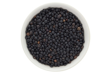 Beluga lentil seeds in white bowl, isolated on white background