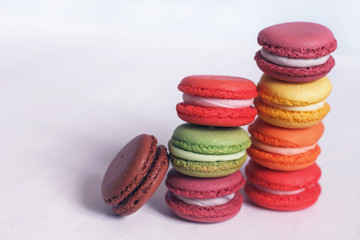colorful macaroons folded in a pile on a white table