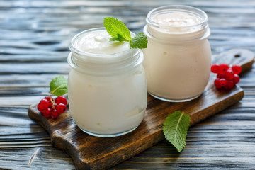 Obraz na płótnie Canvas Homemade yogurt and sour baked milk in glass jars.