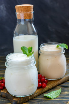 Milk, yogurt and sour baked milk in glass jars.
