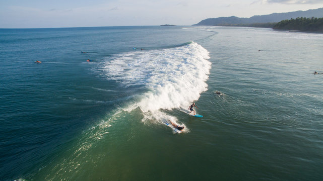 Aerial view of a surfer on a wave in Jaco, Costa Rica