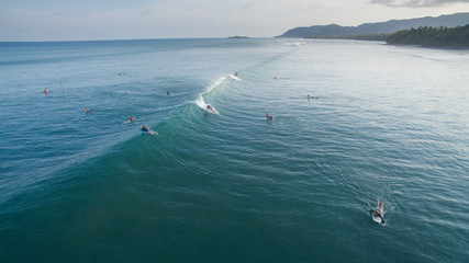 Aerial view of a surfer on a wave in Jaco, Costa Rica