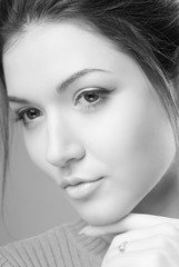 Fototapeta premium Portrait of young brunette woman with clean skin on an isolated background black and white image