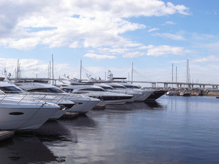 Yachts are on the pier. A clear day, everything is ready for sea walks.