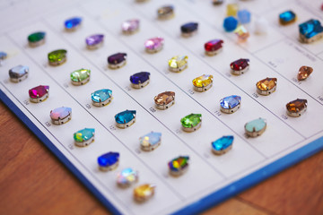 Fototapeta na wymiar Catalog of crystals for embroidery on fabric, elegant luxury sewing accessories
