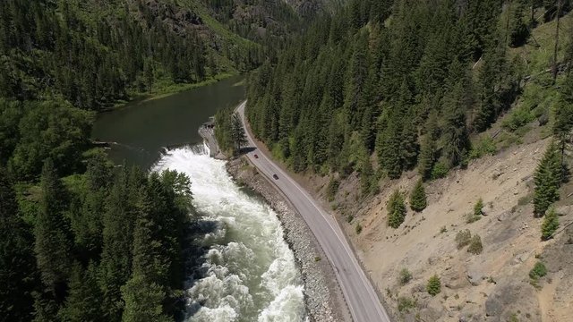 Helicopter View of Travelers on Road Trip Driving by Tumwater Dam in Pacific Northwest