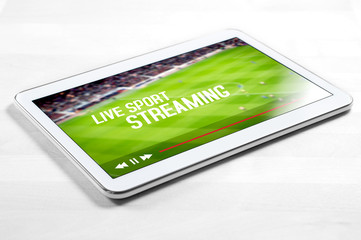 Live sport stream online with mobile device. White tablet on wooden table with imaginary video player and streaming service. © terovesalainen