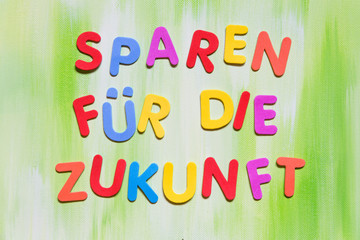 colorful letters, german text, concept spare money for the future
