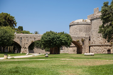 Fototapeta na wymiar Ruins of the castle and city walls of Rhodes. Defensive Fortress of the Joannites.Historic castle on the shores of the Aegean and Mediterranean.