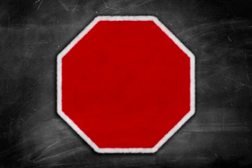 blank stop sign on a black chalkboard
