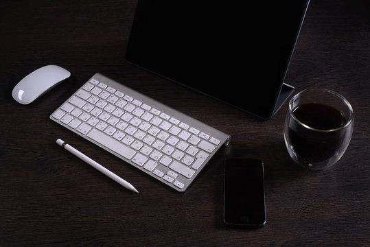 The layout of the freelancer Desk accessories and tool, digital tablet, keyboard,stylus pen,coffee Cup, telephone, business person, working place