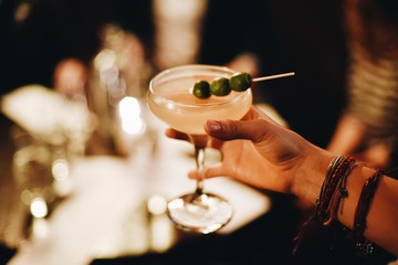 Person holding cocktail 