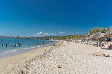 Fototapeta na wymiar Cienfuegos, Cuba – January 1, 2017: Caribbean beach Playa Rancho Luna in Cienfuegos. Sandy coast