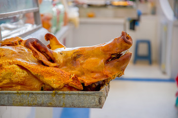 Delicious hornado roasted pork, over a silver tray, ecuadorian traditional typical andean food located in the municipal market in San Francisco in the city of Quito