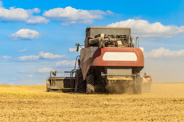 Combine harvester in the field for harvesting. Agricultural machinery, rear view.