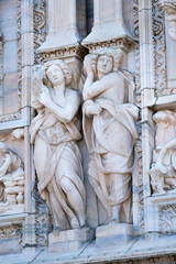 Fototapeta premium Milan, Italy - June, 19, 2017: sculpturs on a wall of Milan Cathedral, Italy