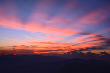 First rays of the rising sun. Misty mountains in the morning. Sunrise at the Adam's Peak (Sri Pada Mountain), Sri Lanka