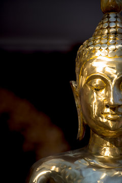 Close up haft of Buddha image face for background.
