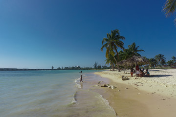 Fototapeta na wymiar playa giron, Cuba – January 2, 2017: Tropical Beach view with people in Playa Giron, Cuba