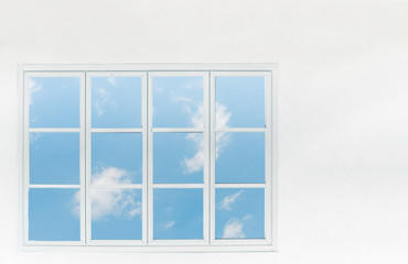Window frame with blue sky on white wall for background.