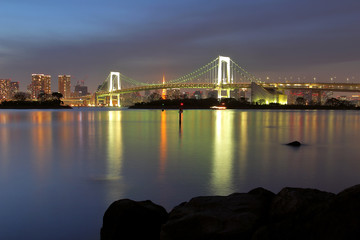 Beautiful scenery during  night time at Tokyo Waterfront night view Rainbow Bridge in Japan. This landmark is a very popular for photographers and tourists. Travel and transportation Concept