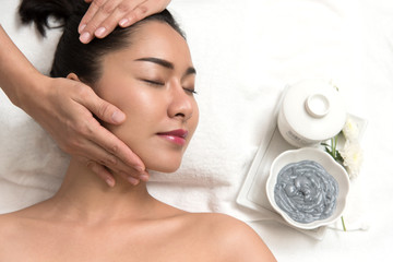 Woman lying and preparation face or head massage in spa