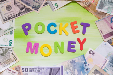 colorful letters and a lot of different currency, pocket money