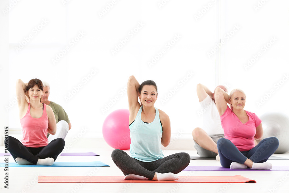 Sticker Group of people practicing yoga in gym