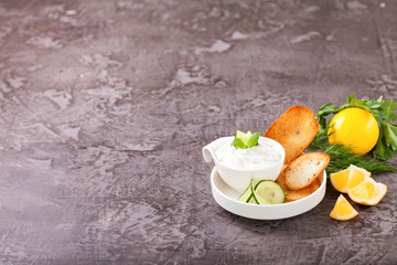 Tzatziki sauce in a  sauce-boat. Ingredients for a dzadziki. Turkish dish cacik. Selective focus. Copy space