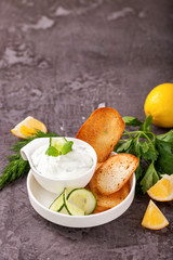 Tzatziki sauce in a  sauce-boat. Ingredients for a dzadziki. Turkish dish cacik. Selective focus. Copy space