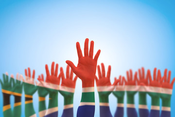 South Africa national flag on leader's palms isolated on blue sky for human rights, leadership, reconciliation concept