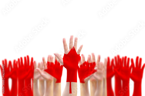 Canada flag pattern pf people's hand raising up on blue sky for national holiday celebration and voting rights