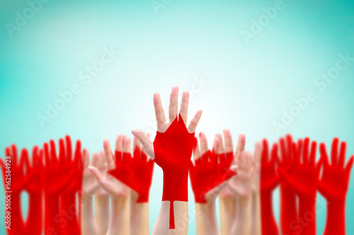 Canada flag pattern pf people's hand raising up on blue sky for national holiday celebration and voting rights