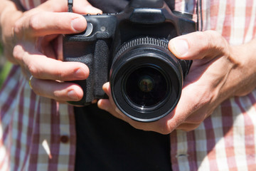 Man photographer with camera in nature