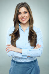 Smiling businesswoman blue shirt dressed standing on gray background.