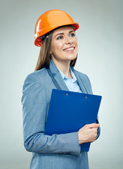 Smiling business woman builder holding clipboard.